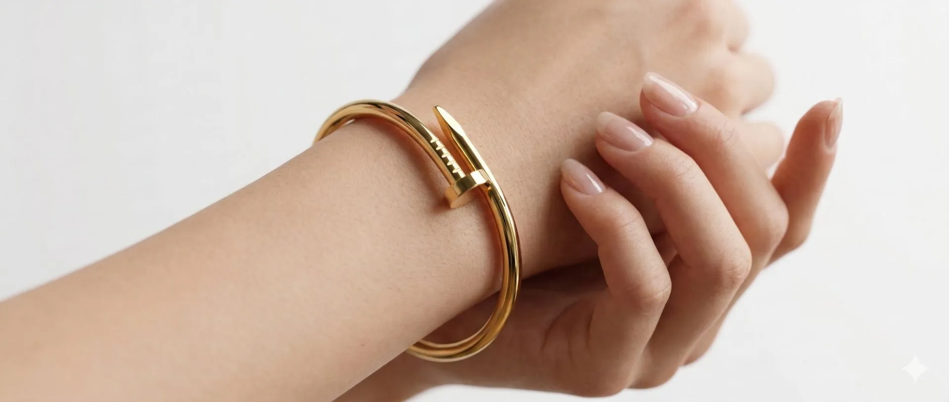 Woman's hand wearing a luxury gold nail bracelet in Pakistan by Zevel